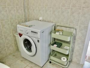 a washer and dryer in a bathroom at Quiet Mountain View Retreat Helicon, Kyriaki in Kiriákion