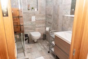 a bathroom with a toilet and a sink at Hotel Victor in Mamaia +29 photos