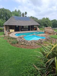 a pool in a yard with a building at The Address Luxurious in Midrand