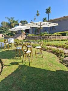a group of chairs and umbrellas in a yard at The Address Luxurious in Midrand