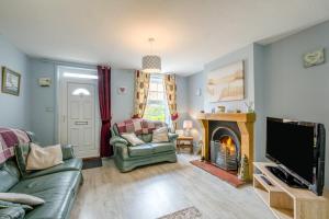 a living room with a tv and a fireplace at 2 Bed in Heacham oc-p29546 in Heacham