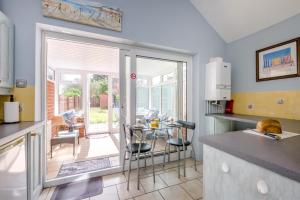 a kitchen with a table and chairs and a patio at 2 Bed in Heacham oc-p29546 in Heacham +13 photos