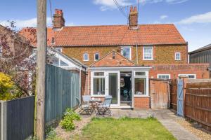 a brick house with a fence and a patio at 2 Bed in Heacham oc-p29546 in Heacham