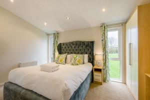 a bedroom with a large bed and a window at Field View 1 bed-No Pets- Walnut in Eye