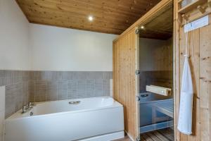 a bathroom with a white tub and a shower at Field View 1 bed-No Pets- Walnut in Eye +12 photos