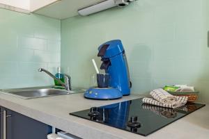 a blue mixer sitting on a kitchen counter at Le Colibri in Foix