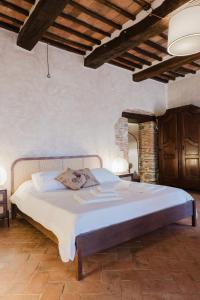 a bedroom with a large bed in a room at Tenuta Fattoria Vecchia in Scansano +105 photos