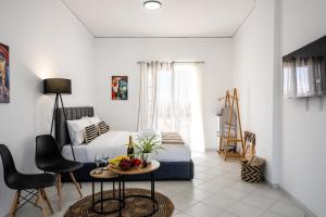a bedroom with a bed and a table and chairs at Studio Scirocco in Tympáki