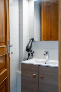 a bathroom with a sink and a mirror at Studio Scirocco in Tympáki +25 photos