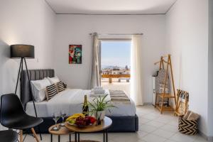 a bedroom with a bed and a table with fruit on it at Studio Scirocco in Tympáki