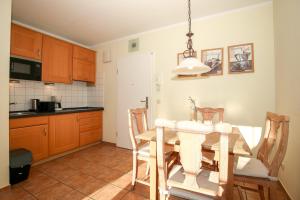 a kitchen with a dining room table and chairs at Ostseewelle Wohnung 24 in Kühlungsborn