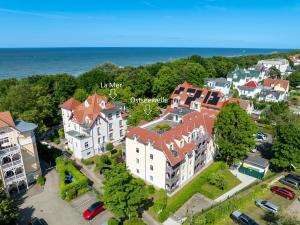 an aerial view of a large house with the ocean at Ostseewelle Wohnung 24 in Kühlungsborn