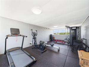 a gym with several exercise equipment in a room at Widemouth Waves Holiday Chalet in Poundstock