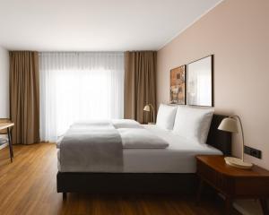 a hotel room with a large bed and a window at Limehome Düsseldorf Pionierstraße in Düsseldorf +40 photos