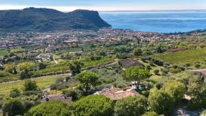 an aerial view of a village in a valley with trees at Villa Rosa del Garda Golf and Bike in Garda