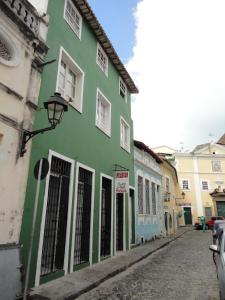 a green building on the side of a street at Pousada Suítes Do Pelô in Salvador