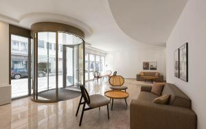 a living room with a couch and a table and chairs at Limehome Düsseldorf Pionierstraße in Düsseldorf