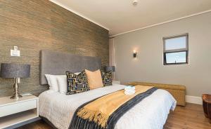 a bedroom with a large bed and a window at The Gallery 204 Luxury Apartment in Knysna
