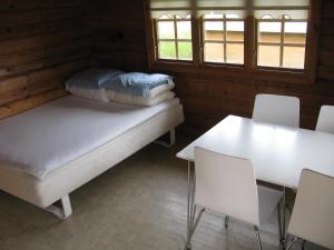 a room with two beds and a table and chairs at Vikær Strand Camping & Cottages in Diernæs