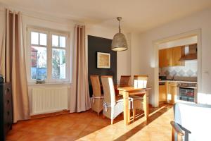 a kitchen and dining room with a table and chairs at Villa Seepferdchen Wohnung 01 in Kühlungsborn +12 photos