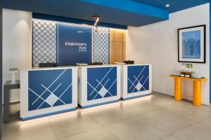 a lobby with blue and white doors and a table at Four Points Flex by Sheraton Madrid Atocha in Madrid