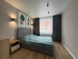a small bedroom with a bed and a window at 2 кім кв BIG APARTMENT TOP Center in Sumy