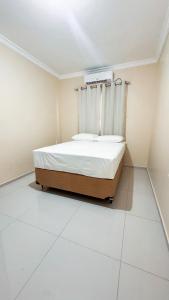 a bedroom with a bed in a white room at Ed Flat Valdeliza Pio in Teresina