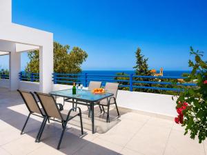 a patio with a table and chairs and the ocean at Villa Eagles Nest in Pachyammos