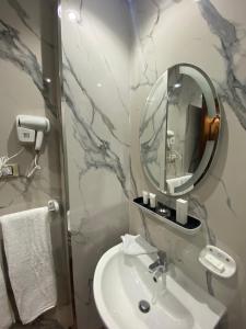 a bathroom with a sink and a mirror at Rehana Pyramids View in Cairo +46 photos
