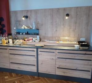a kitchen with wooden cabinets and a counter top at Ferienhotel Münch in Neukirchen beim Heiligen Blut