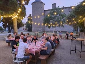 a group of people sitting at tables at a restaurant at Les Cabanes Dans Les Bois Logis Hôtel in Villalier +124 photos