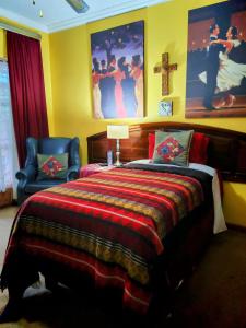 a bedroom with a bed and a cross on the wall at Leopard Lily in Potchefstroom