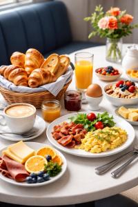 a table with plates of breakfast food on it at Seb & Co in Paris