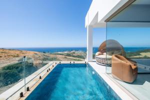 a swimming pool in a house with a view of the ocean at Le Tanger Résidence Hôtelière in Tangier