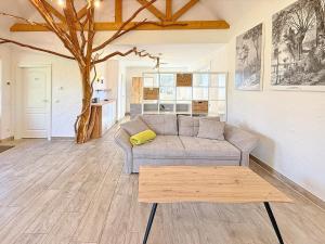 a living room with a couch and a coffee table at Eichengrund Baum 7 in Burg