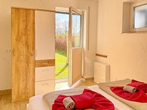 a bedroom with two beds and a sliding glass door at Eichengrund Baum 7 in Burg