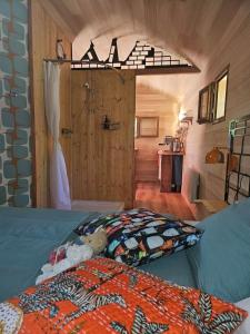 a bedroom with a bed and a door in a room at La nuitée belle in Cénevières