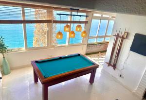 a pool table in a room with windows at El Barco in Almería