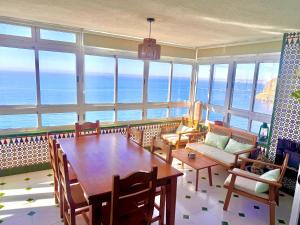 a dining room with a table and views of the ocean at El Barco in Almería