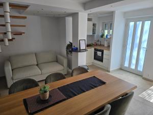 a living room with a table and a couch at Vlaškovec Experience in Plešivica