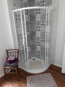 a shower with a glass enclosure in a room with a chair at Chambres d'Hôtes et Table d'Hôtes- Valentine 44 in Sainte-Mère-Église +37 photos