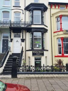 a building with a sign on the front of it at Windsor House Hotel in Blackpool