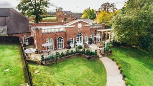 an aerial view of a brick house with a yard at The Farmhouse in Derby