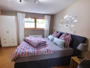 a bedroom with a bed with a blanket on it at Ferienwohnung Gaß in Kastellaun