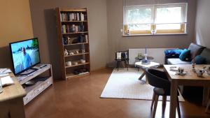 a living room with a couch and a tv and a table at Ferienwohnung Gaß in Kastellaun +8 photos
