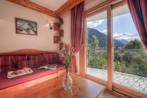 a living room with a couch and a large window at Résidence Le Cristal Apartments in Chamonix