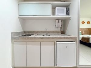 a small kitchen with a sink and a microwave at STAY Cosmopolitan in Palmas