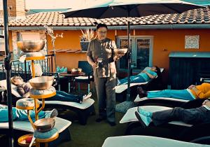 a man standing in a room with tables and chairs at Bed & Breakfast Villa Adriana in Premantura