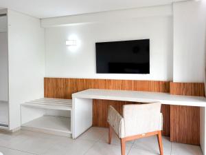 a white desk with a tv and a chair at STAY Cosmopolitan in Palmas