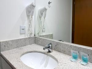 a bathroom counter with a sink and a mirror at STAY Cosmopolitan in Palmas